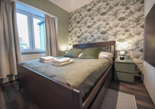 a bedroom with a bed with towels on it at Apartamenty na Wyspie -Apartamenty Stella in Świnoujście