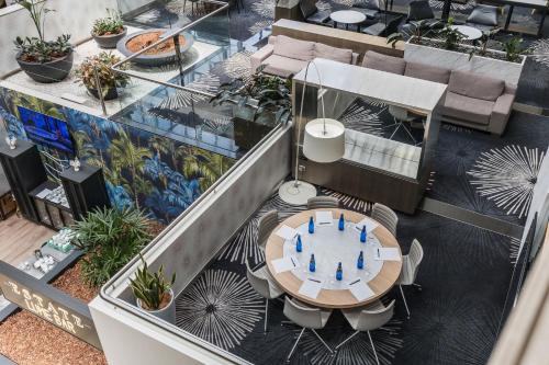 an overhead view of a restaurant with a table and chairs at Crowne Plaza Canberra by IHG in Canberra