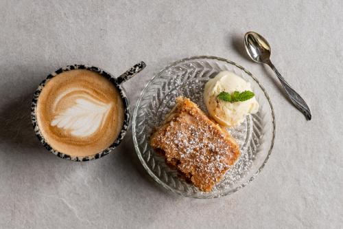 a plate with a piece of cake and a cup of coffee at Willa Amicus in Zakopane