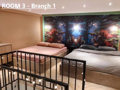two beds in a room with a mural on the wall at Nhà Yên 1 Bed 2 Beds Hotel Homestay Hostel Cần Thơ in Can Tho