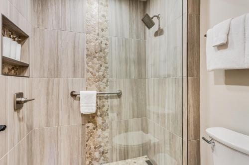 a bathroom with a shower with a glass door at Laurelwood Condominiums 107 in Snowmass Village