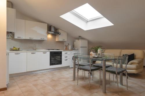 a kitchen and dining room with a table and a window at Archi di Vesna in Ancona