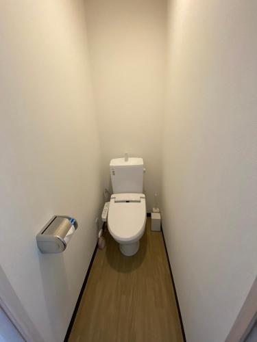 a small bathroom with a toilet in a stall at MR TOMO FUJI in Fuji