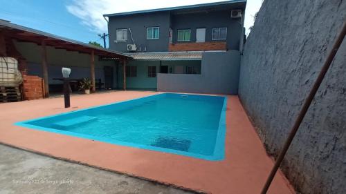 a swimming pool in the courtyard of a house at jazmin apart iguazu in Puerto Iguazú