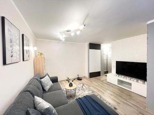 a living room with a couch and a tv at Comfort Apartment In Narva City Center in Narva