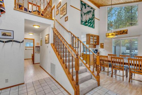 a dining room and kitchen with a staircase in a house at Big Leaf - Unit 6 in Sunriver