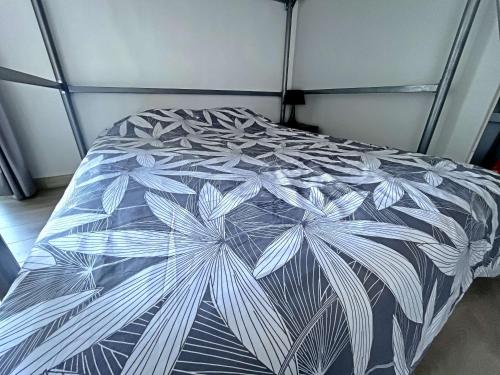 - un lit avec une couette en noir et blanc dans l'établissement Studio 23m² avec Parking Privé, Ascenseur, Proche Mer - Berck - FR-1-646-19, à Berck-sur-Mer