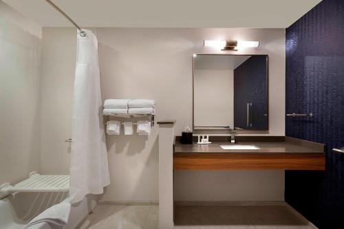 a bathroom with a sink and a mirror at Fairfield Inn & Suites by Marriott Shelby in Shelby