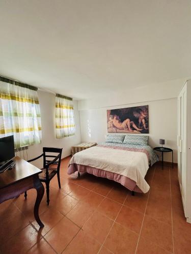 a bedroom with a bed and a table and a desk at B&B Panta Rei in Arezzo