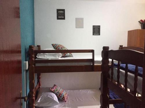 a bedroom with two bunk beds in a room at Canto da Praia Suítes in Arraial do Cabo