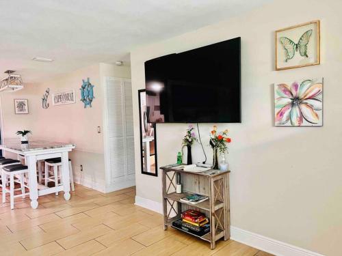 a living room with a flat screen tv on a wall at Cozy 2 bedrooms home by the water in Cape Coral