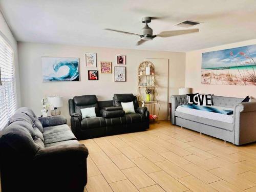 a living room with a couch and a bed at Cozy 2 bedrooms home by the water in Cape Coral