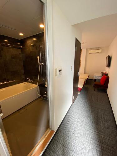 a room with a bathroom with a tub and a shower at MR TOMO FUJI in Fuji