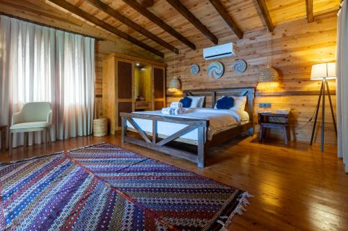 a bedroom with a bed and a wooden wall at La Boheme Kabak Adults Only in Faralya