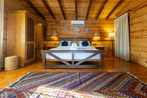 a bedroom with a bed in a wooden cabin at La Boheme Kabak Adults Only in Faralya
