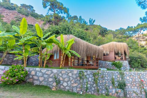 a resort with a stone wall in front of a building at La Boheme Kabak Adults Only in Faralya