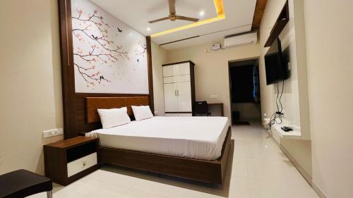 a bedroom with a bed and a television in it at NKP Residency in Alāndurai