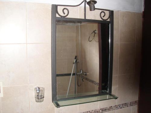 a mirror on the wall of a shower in a bathroom at La Pastora in Punta del Este