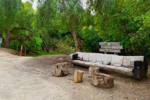 a wooden bench sitting in the middle of a park at Hello Sunshine OC minutes to Disneyland-Family Friendly in Fullerton