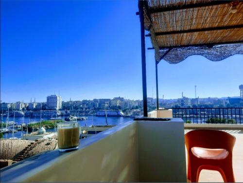 a drink on a table with a view of a harbor at FADL Kato in Aswan