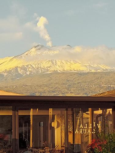a view of a snow covered mountain from a window at Villa Laura Apartment in Giardini Naxos