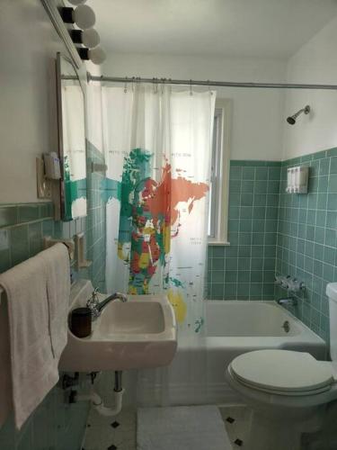 a bathroom with a sink and a toilet and a tub at Cozy house near Lake Erie, 10 minutes to Downtown. in Cleveland