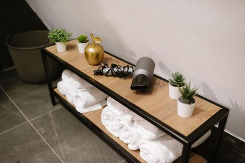 a shelf with towels and plants in a room at Pinery Blidinje A-Frame House in Blidinje