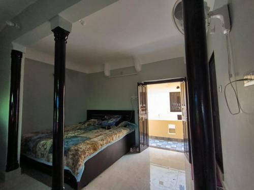 a bedroom with a bed and a mirror at Pink City Backpackers in Jaipur