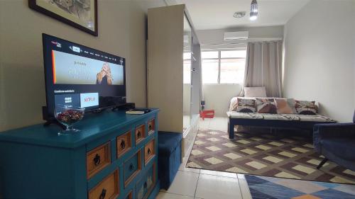 a living room with a flat screen tv on a dresser at Studio Canadá: Custo-Benefício $ in Florianópolis