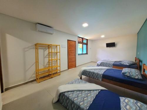 a room with three beds and a ladder in it at Suítes Barra da Lagoa in Ubatuba