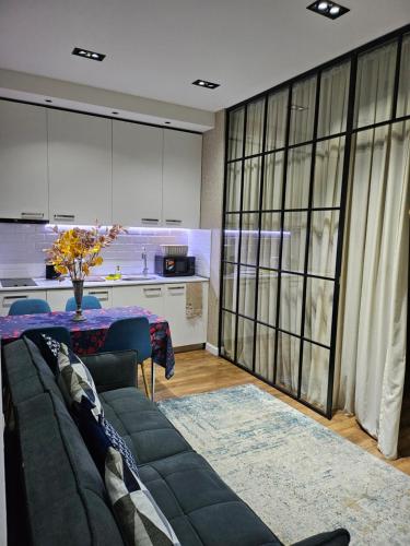a living room with a couch and a table at Nova city center apartments in Tbilisi City