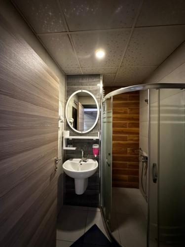 a bathroom with a sink and a mirror at Comfort Başaran OTEL in Antalya