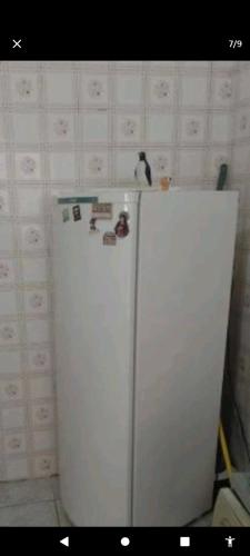 a white refrigerator in a room with a wall at Mansão bairro nobre in Campinas