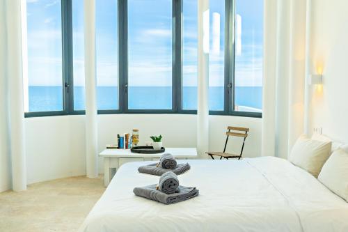 a bedroom with a bed with towels on it at CasaCarbonito in Carboneras