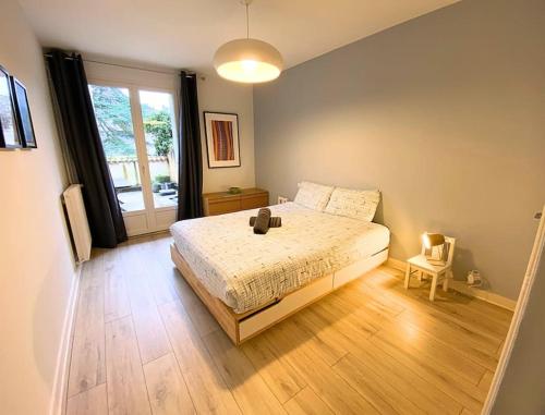 ein Schlafzimmer mit einem Bett und einem großen Fenster in der Unterkunft L'Appart' de Famille - 6 pers - Poitiers Centre in Poitiers