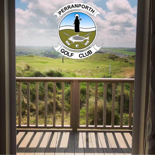 a view of a golf club sign from a window at Perranporth Golf Club Self-Catering Holiday Accommodation in Perranporth