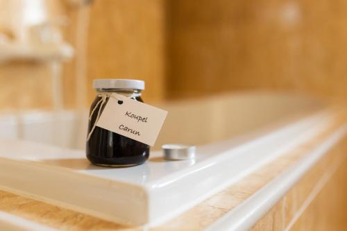 a jar of honey sitting on a shelf in a bath tub at ROMANTIK HOTEL ELEONORA in Tábor