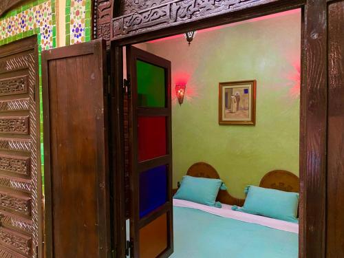 a room with two beds in a room with a doorway at Riad Nezha in Marrakesh