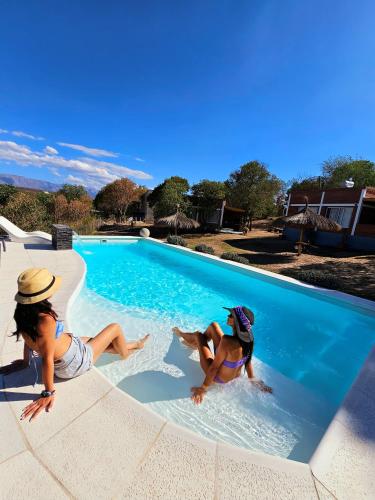 two women are playing in a swimming pool at Los Molles Suites -Solo 2 Pax- in Mina Clavero