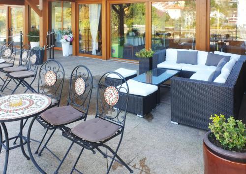 a patio with chairs and a table and a couch at ROMANTIK HOTEL ELEONORA in Tábor
