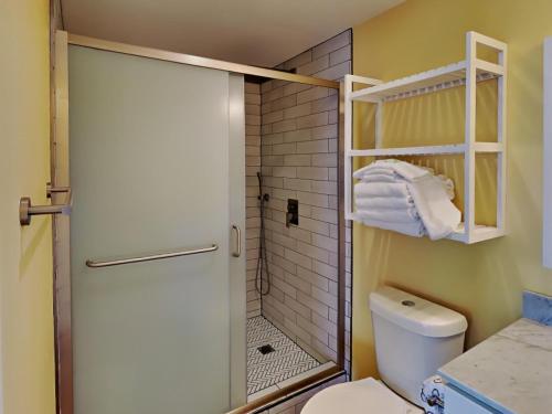 a small bathroom with a shower and a toilet at Emerald Isle #401 in Pensacola Beach