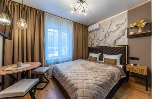 a hotel room with a bed and a table at MYFREEDOM Апартаменти пр-т Правди 6 in Kyiv