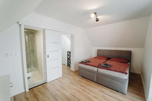 Un dormitorio con una cama con almohadas rojas. en Double Floor Apartment With 2 Terraces en Veľká Lomnica