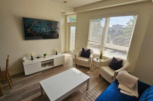 a living room with a couch and a table at Modern 2BR Townhouse w Patio & Free Parking Family & Work Stays in Toronto