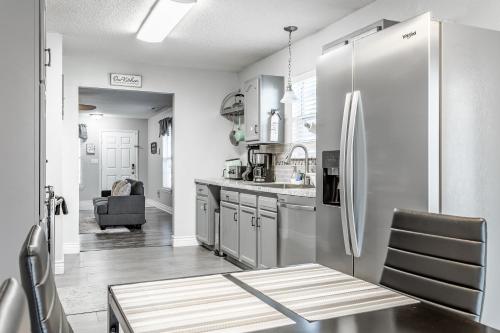 a kitchen with a stainless steel refrigerator at King Size Bed Bungalow with a Gym in Indianapolis in Indianapolis