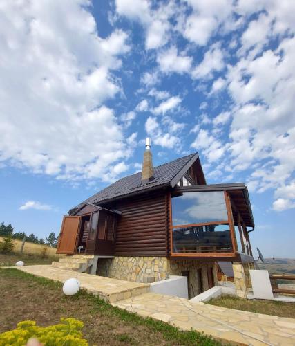 a house with a large window on the side of it at Zlatibor Sky Inn in Zlatibor