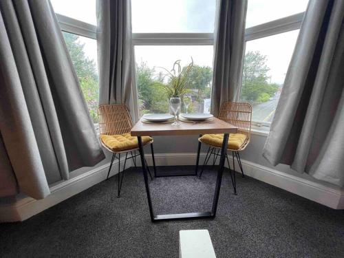 a table and chairs in a room with a window at Serviced Apartment- 1 Bed-Next To Train Station in Sleightholme