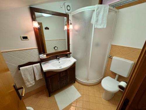 a bathroom with a sink and a shower and a toilet at Liuby Home in Sestriere