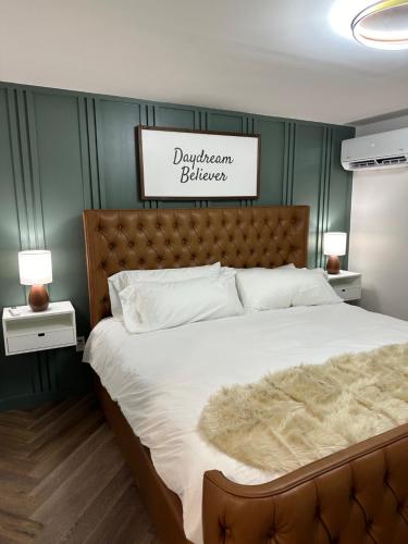 a bedroom with a large bed with a brown headboard at Chalet 239-Boutique Hotel in West Dover