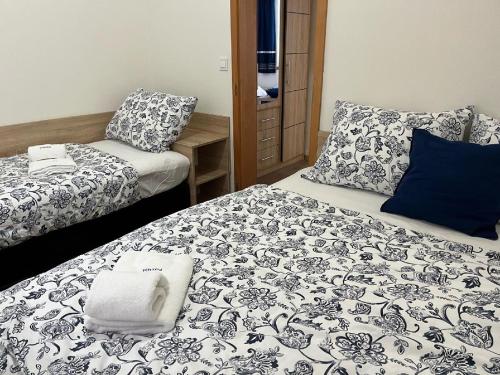 a room with two beds and a pillow on a bed at Penzion POSADA in Podivín